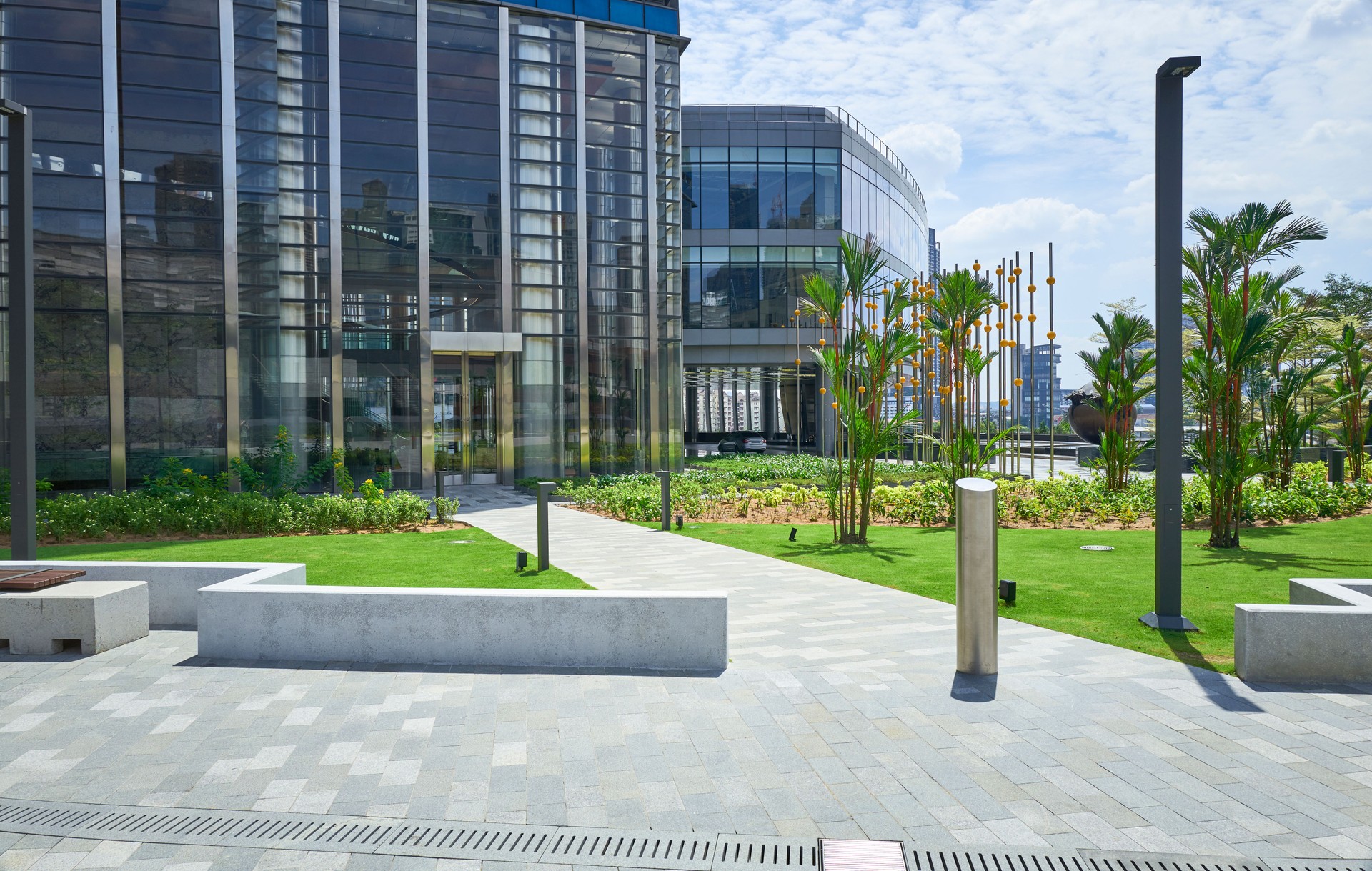 Modern office building with landscaped grounds showing walkway leading to entrance